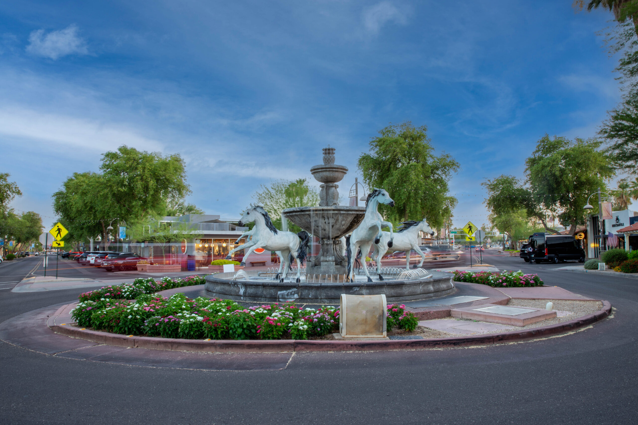 Pario_Bishop_lifestyle_2 - fountain with horses and flowers around it.