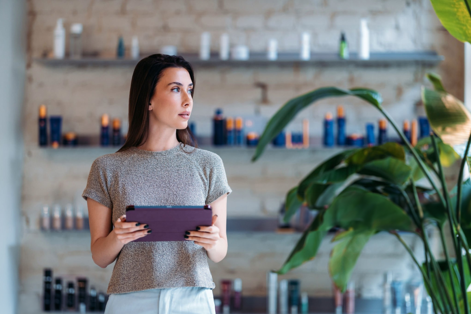 Fashion District - A woman holding an Ipad while looking around