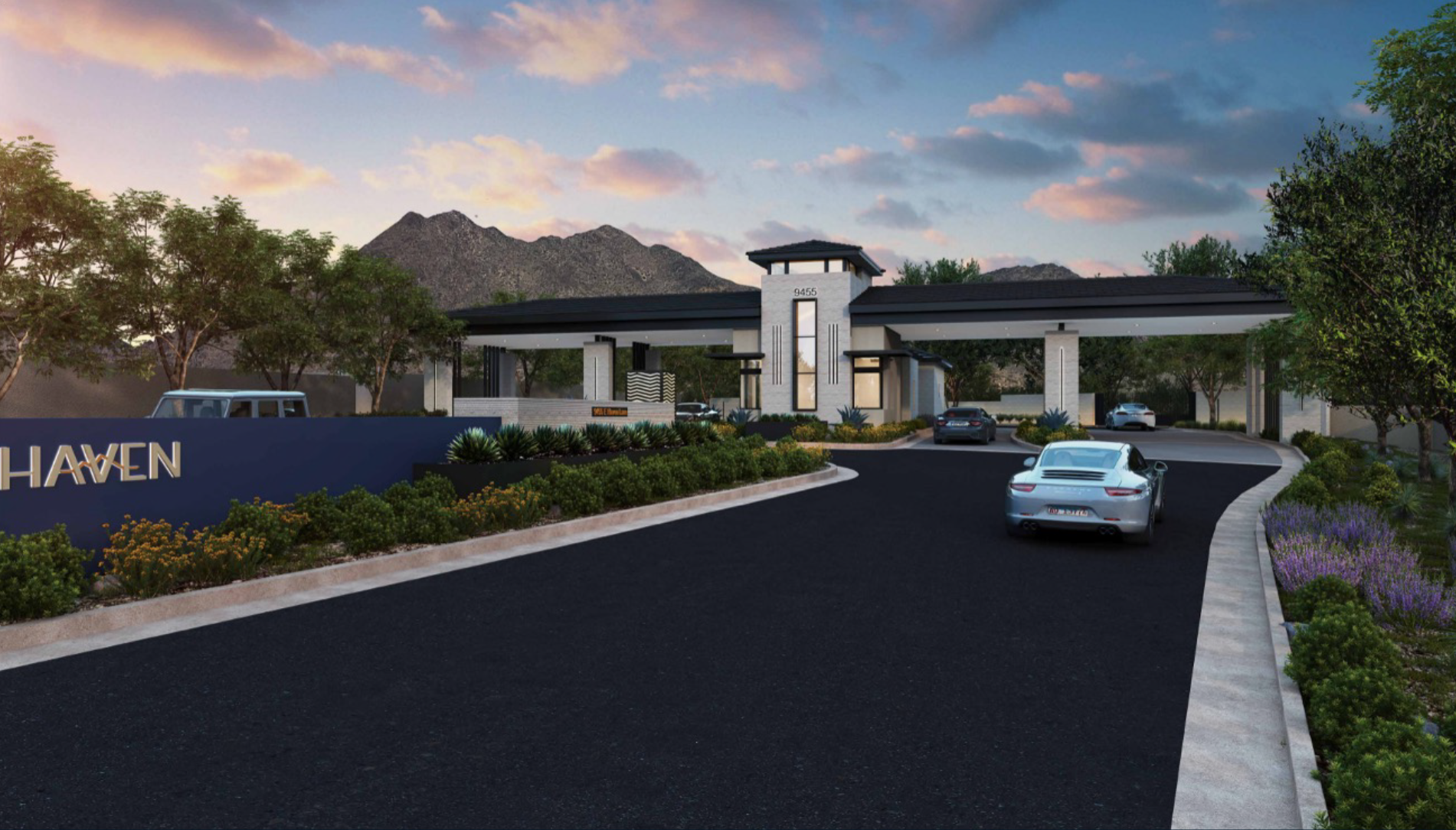 Haven - Modern gated community entrance with sleek architecture, landscaped greenery, and mountain backdrop at sunset.